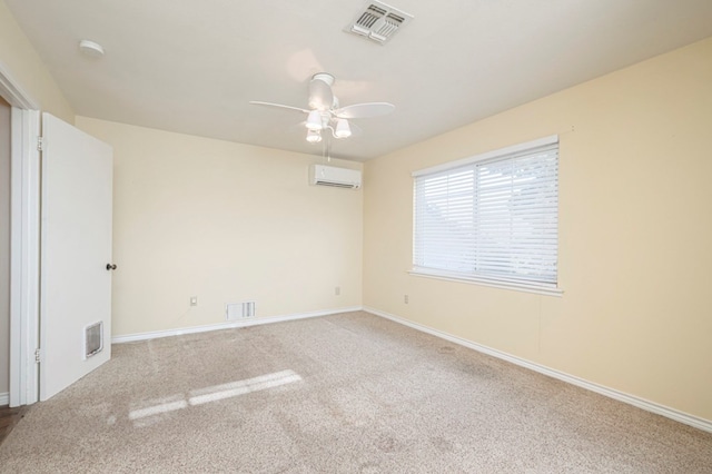 empty room with a wall unit AC, ceiling fan, visible vents, and carpet flooring