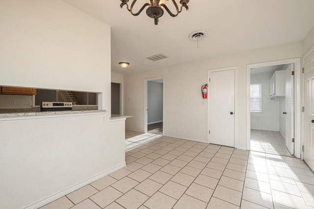 unfurnished room featuring light tile patterned floors, baseboards, and visible vents