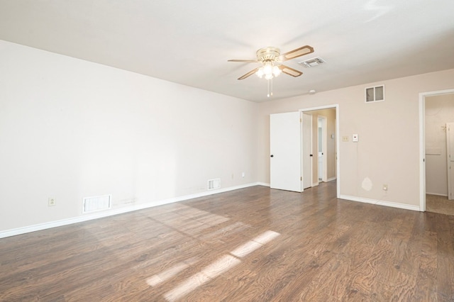 empty room with a ceiling fan, visible vents, and wood finished floors