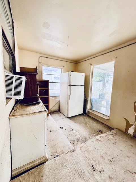 kitchen with white fridge and a wealth of natural light