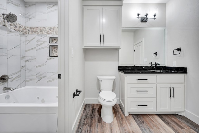 full bathroom featuring hardwood / wood-style flooring, tiled shower / bath combo, toilet, and vanity