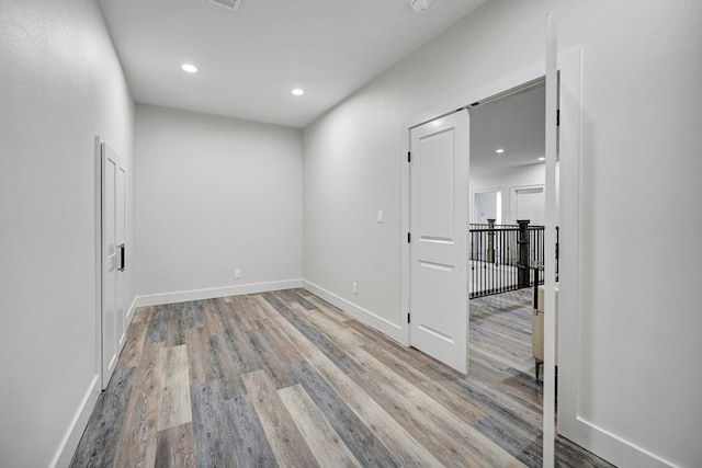 empty room with light hardwood / wood-style flooring