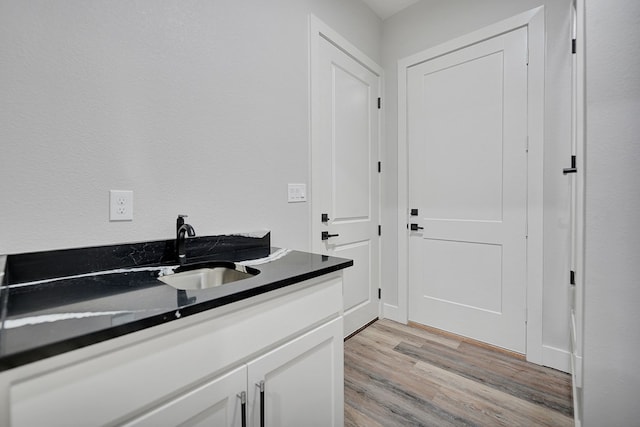 bathroom with vanity and wood-type flooring