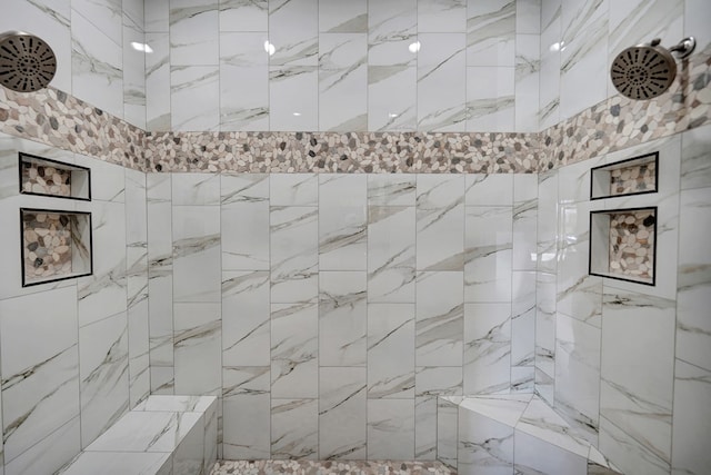 bathroom with a tile shower