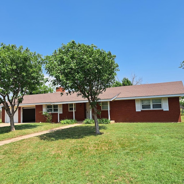 single story home featuring a garage and a front lawn