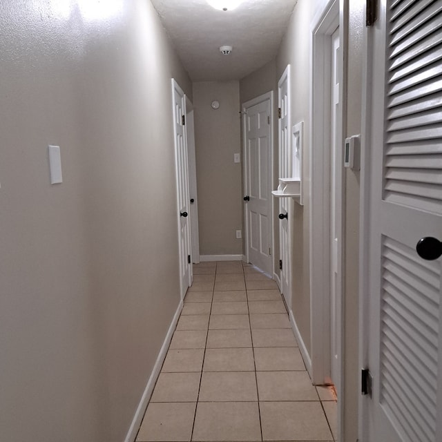 corridor with light tile patterned floors