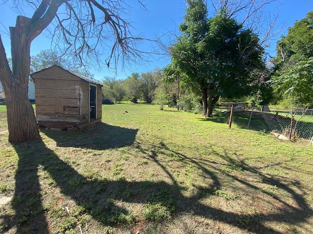 view of yard featuring fence and an outdoor structure