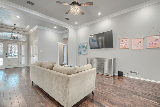 7005 Ridgeboro Ct, Midland, TX 79707 - living room with dark wood-style floors, a chandelier, ornamental molding, baseboards, and a ceiling fan