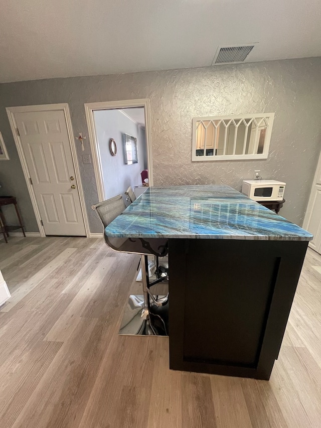 2804 33rd St, Snyder, TX 79549 - recreation room featuring a textured wall and light wood-style floors