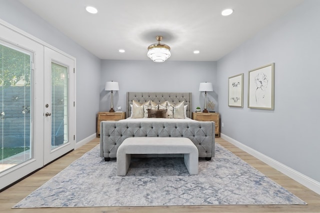 bedroom with access to exterior, light hardwood / wood-style flooring, and french doors