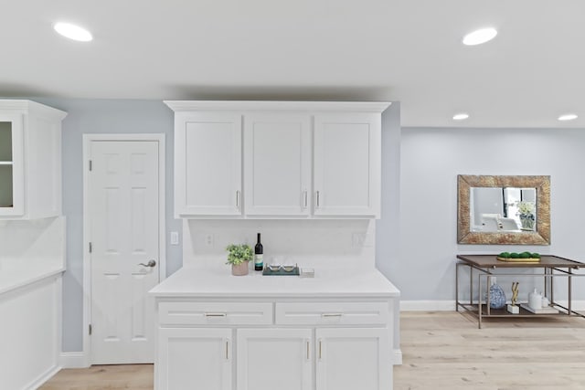 kitchen featuring white cabinetry and light hardwood / wood-style floors