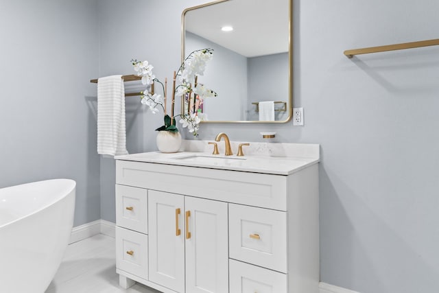 bathroom featuring tile patterned floors, vanity, and a tub to relax in