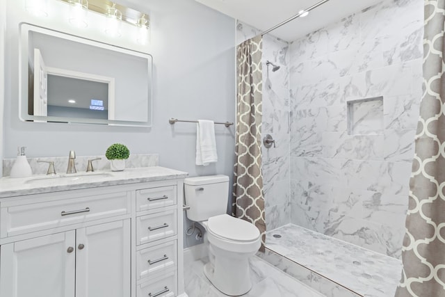 bathroom featuring vanity, a shower with shower curtain, and toilet