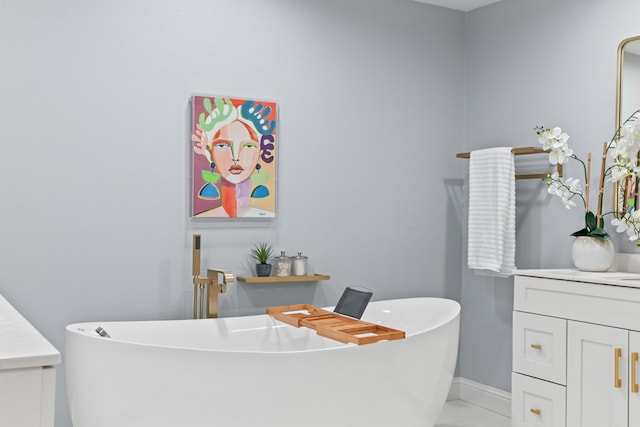 bathroom with tile patterned flooring, vanity, and a washtub