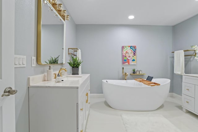 bathroom with a washtub and vanity