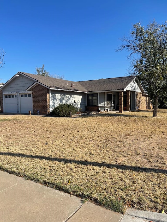 4400 Palmer Dr, Midland, TX 79705 - ranch-style home with a garage, brick siding, and a porch