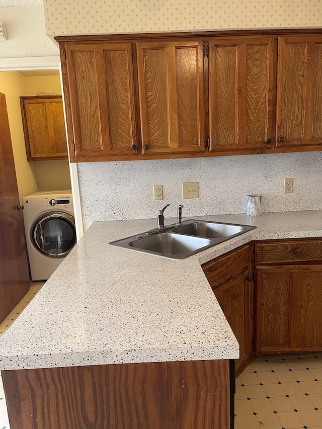 4400 Palmer Dr, Midland, TX 79705 - kitchen with washer / clothes dryer, a sink, light countertops, and brown cabinets