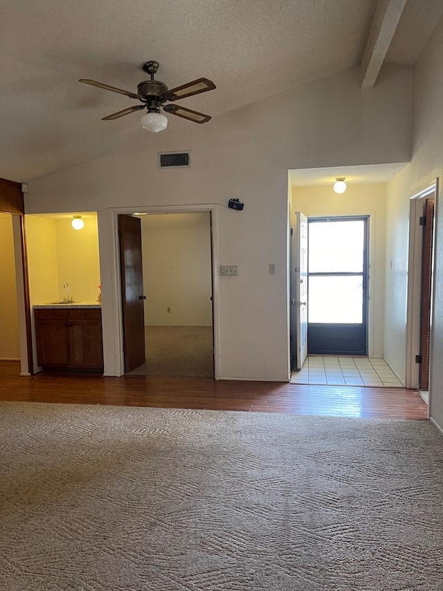4400 Palmer Dr, Midland, TX 79705 - unfurnished room featuring carpet flooring, ceiling fan, a sink, wood finished floors, and a textured ceiling
