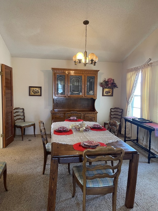 4400 Palmer Dr, Midland, TX 79705 - dining room featuring carpet, a chandelier, and a textured ceiling