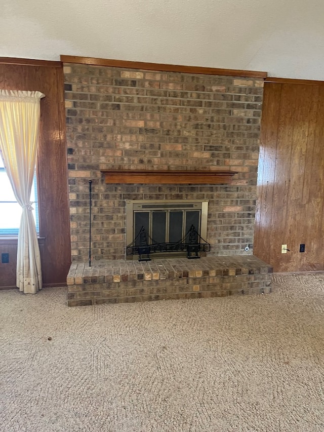 4400 Palmer Dr, Midland, TX 79705 - detailed view of carpet, wood walls, and a brick fireplace