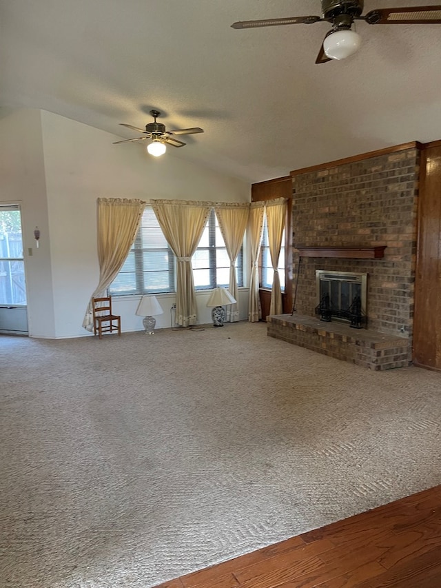 4400 Palmer Dr, Midland, TX 79705 - unfurnished living room with a ceiling fan, vaulted ceiling, a brick fireplace, carpet, and a textured ceiling