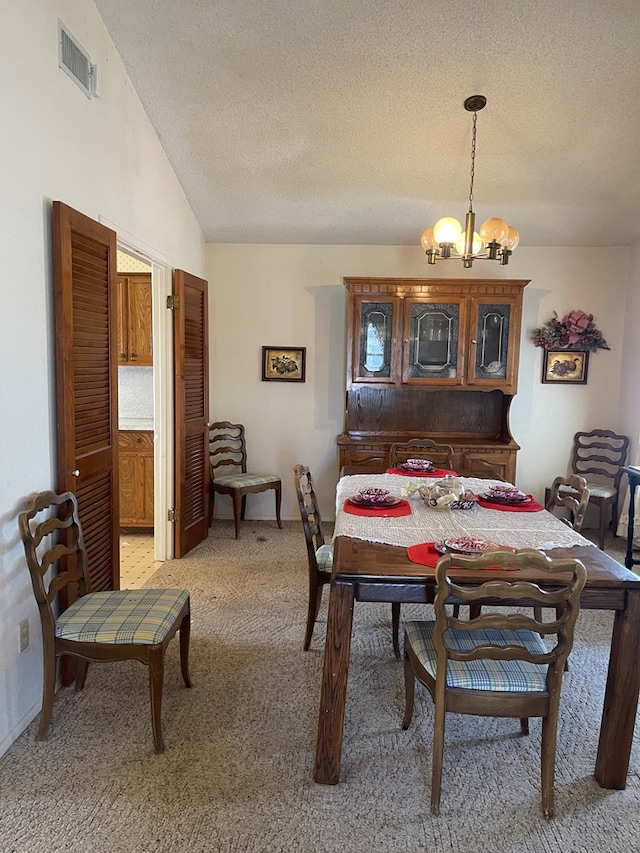 4400 Palmer Dr, Midland, TX 79705 - dining room featuring a chandelier, light colored carpet, a textured ceiling, and lofted ceiling