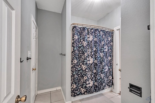 bathroom featuring tile patterned flooring and baseboards