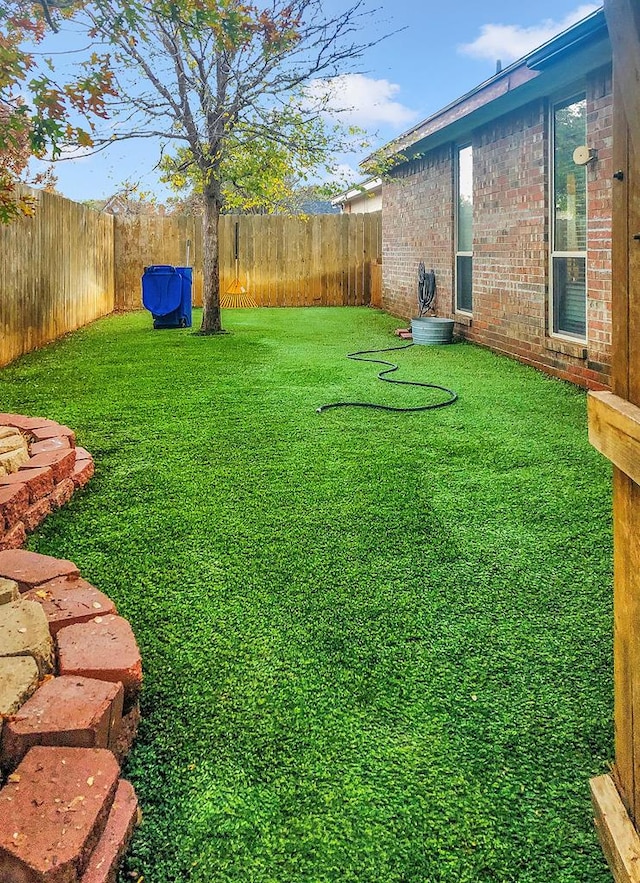 view of yard with a fenced backyard