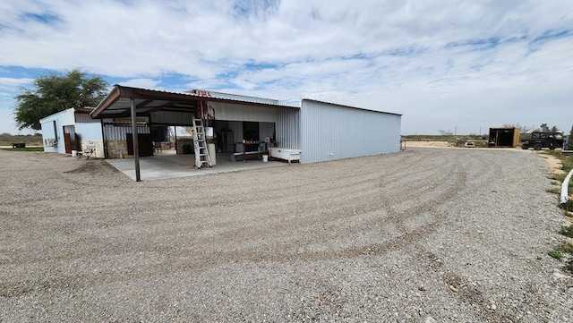 rear view of property with an outbuilding