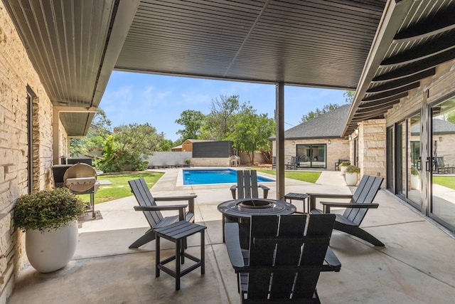 1611 W Tennessee Ave, Midland, TX 79701 - view of patio / terrace with an outdoor fire pit, a fenced backyard, a storage unit, an outbuilding, and area for grilling