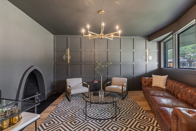1611 W Tennessee Ave, Midland, TX 79701 - living area featuring a decorative wall, light wood-type flooring, and a chandelier