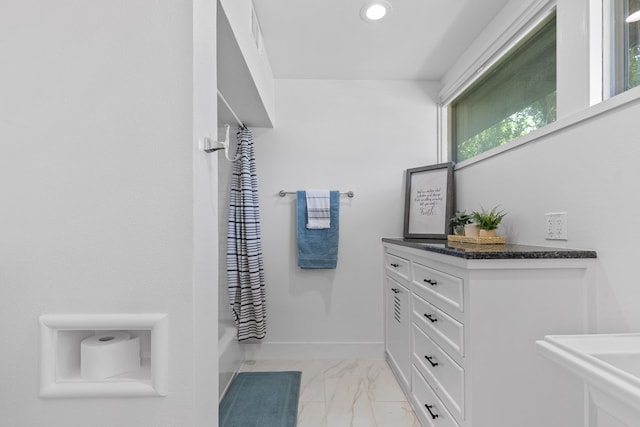 1611 W Tennessee Ave, Midland, TX 79701 - bathroom with marble finish floors, shower / tub combo, recessed lighting, and baseboards