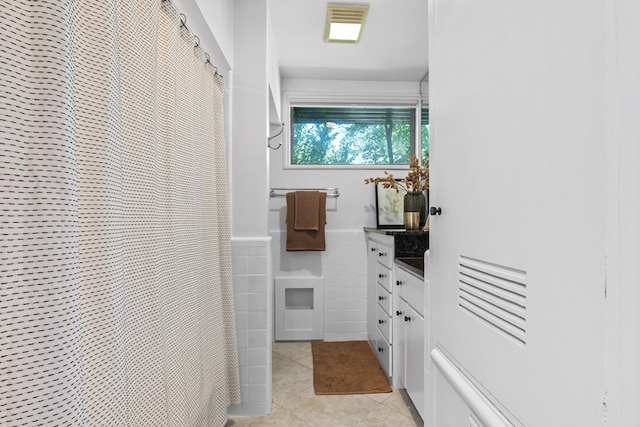 1611 W Tennessee Ave, Midland, TX 79701 - full bathroom with vanity, tile walls, tile patterned floors, a heating unit, and a shower with curtain