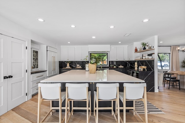 1611 W Tennessee Ave, Midland, TX 79701 - kitchen featuring plenty of natural light, open shelves, a center island, a kitchen bar, and recessed lighting