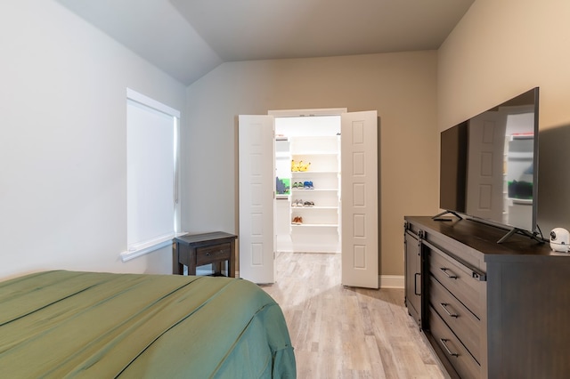 6004 Silent Rain, Midland, TX 79705 - bedroom with light wood-style floors, lofted ceiling, and a walk in closet