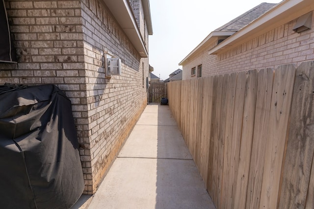 6004 Silent Rain, Midland, TX 79705 - view of side of property featuring brick siding and roof with shingles