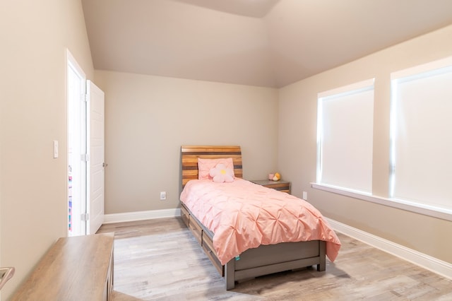 6004 Silent Rain, Midland, TX 79705 - bedroom with light wood-style floors and lofted ceiling