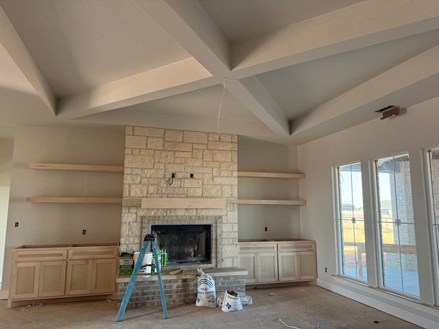 unfurnished living room with beam ceiling, built in features, and a fireplace