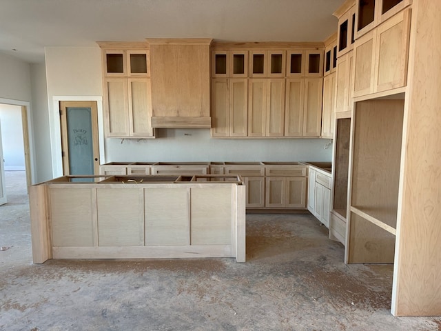 kitchen with light brown cabinetry and a kitchen island