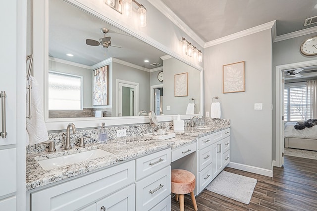 full bathroom with double vanity, a ceiling fan, wood finished floors, ensuite bathroom, and a sink