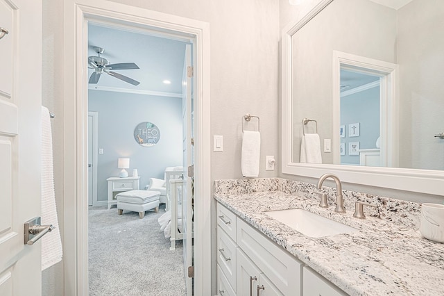 bathroom featuring ceiling fan, vanity, and crown molding