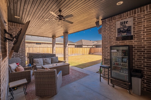 view of patio / terrace with a ceiling fan, a fenced backyard, and an outdoor hangout area