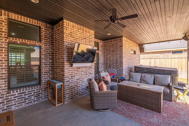 view of patio / terrace featuring fence, an outdoor hangout area, and a ceiling fan