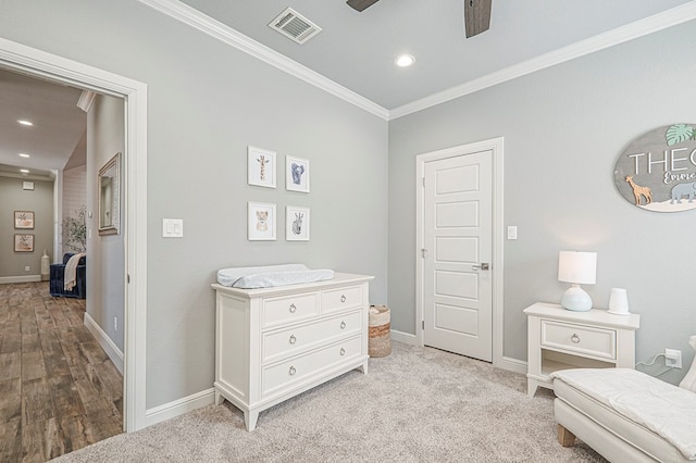 interior space featuring baseboards, visible vents, ceiling fan, and ornamental molding