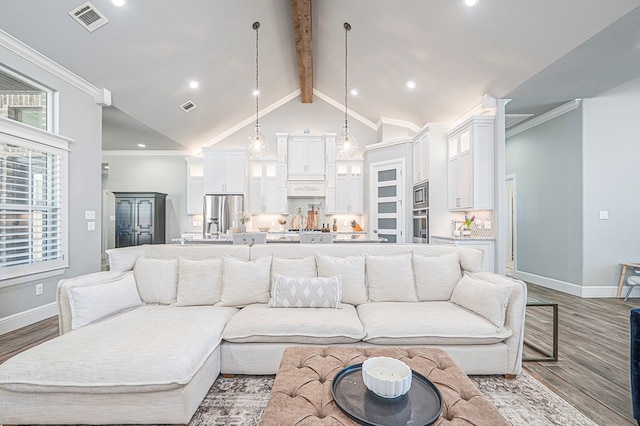 living area featuring baseboards, visible vents, ornamental molding, wood finished floors, and beam ceiling