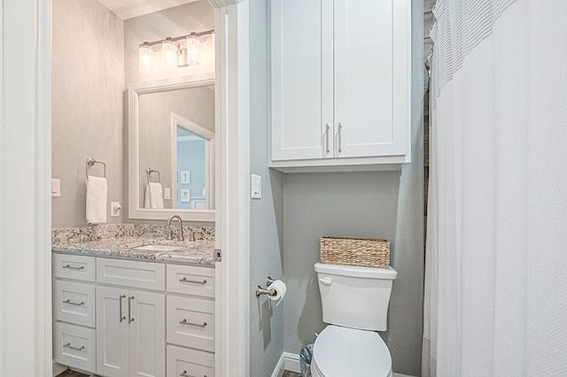 full bathroom featuring vanity and toilet