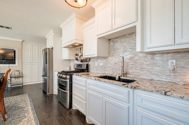 kitchen with white cabinetry, sink, dark wood-type flooring, stainless steel appliances, and ornamental molding