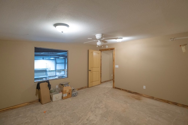 spare room with ceiling fan and a textured ceiling