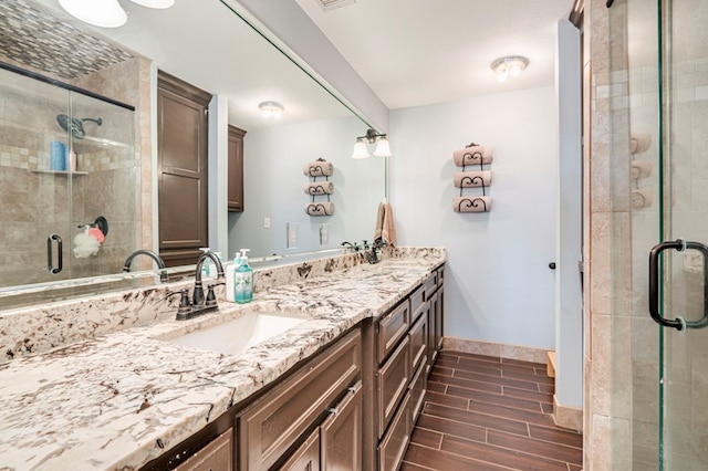 bathroom with vanity and a shower with shower door