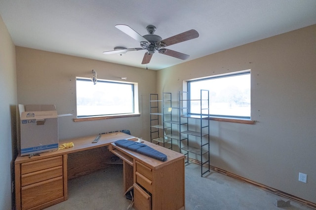 office featuring light carpet and ceiling fan